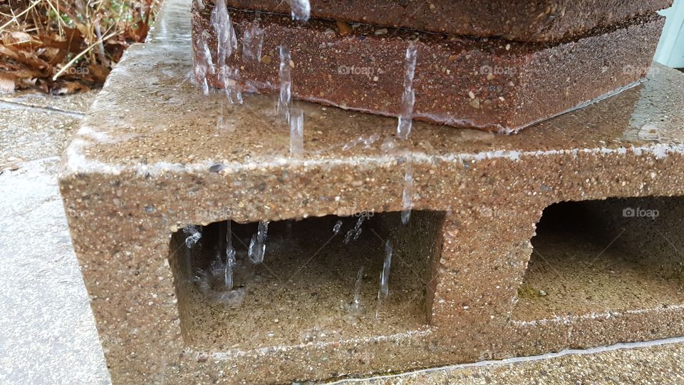 rain barrel overflowing on a rainy day