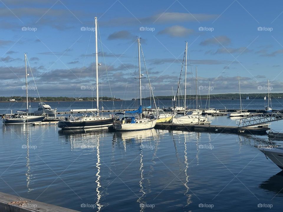 Boats off the shore, boats floating peacefully, boats in the water, floating boats in Canada 