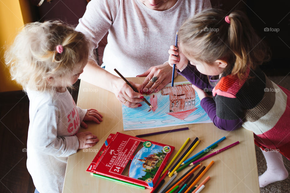 Colours of the world. Children with mom drawing using crayons