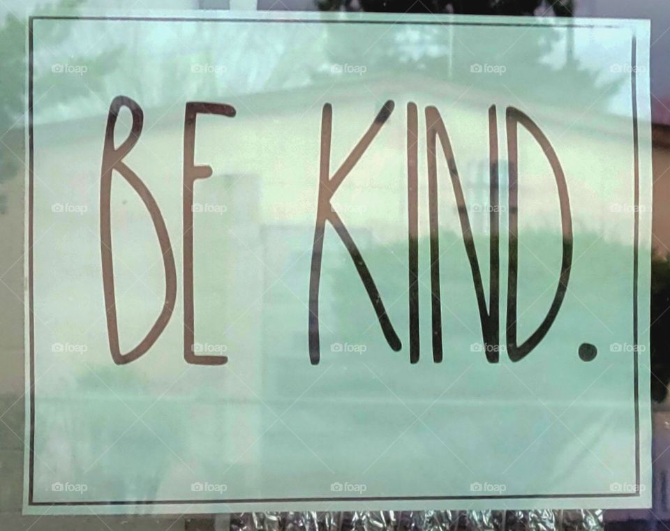 Be kind written on paper in Grade school slass room window