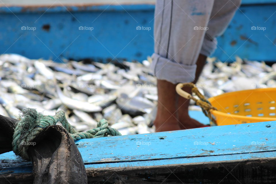 Low section of fisherman on boat