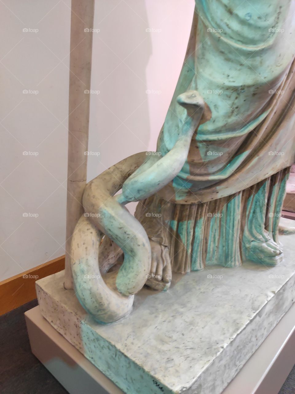 Snake carved on basis of the sculpture