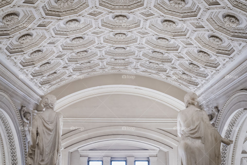 Way to the light between two statues of Roman goddesses in Rome 