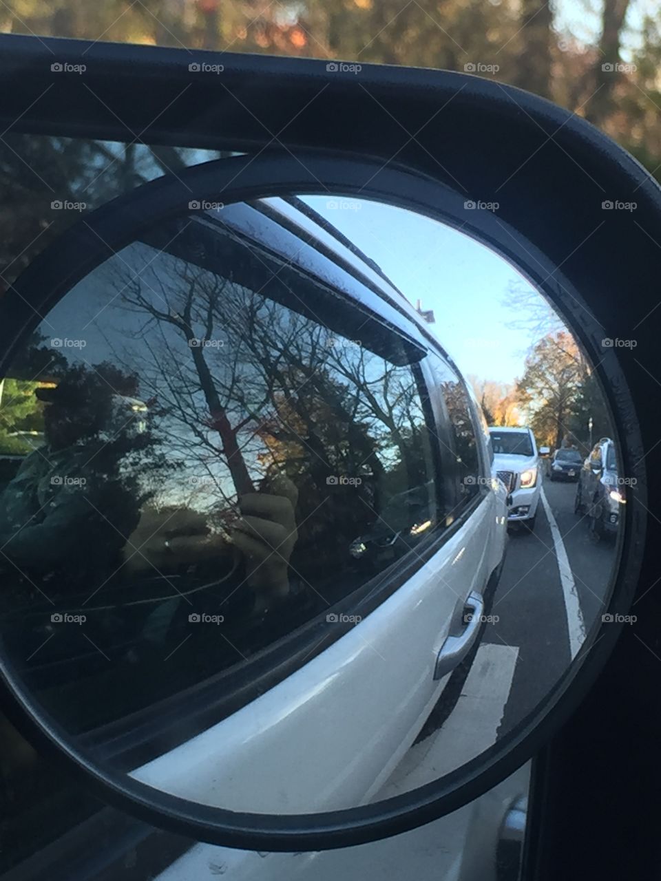 Side mirror of Toyota FJ on highway in traffic