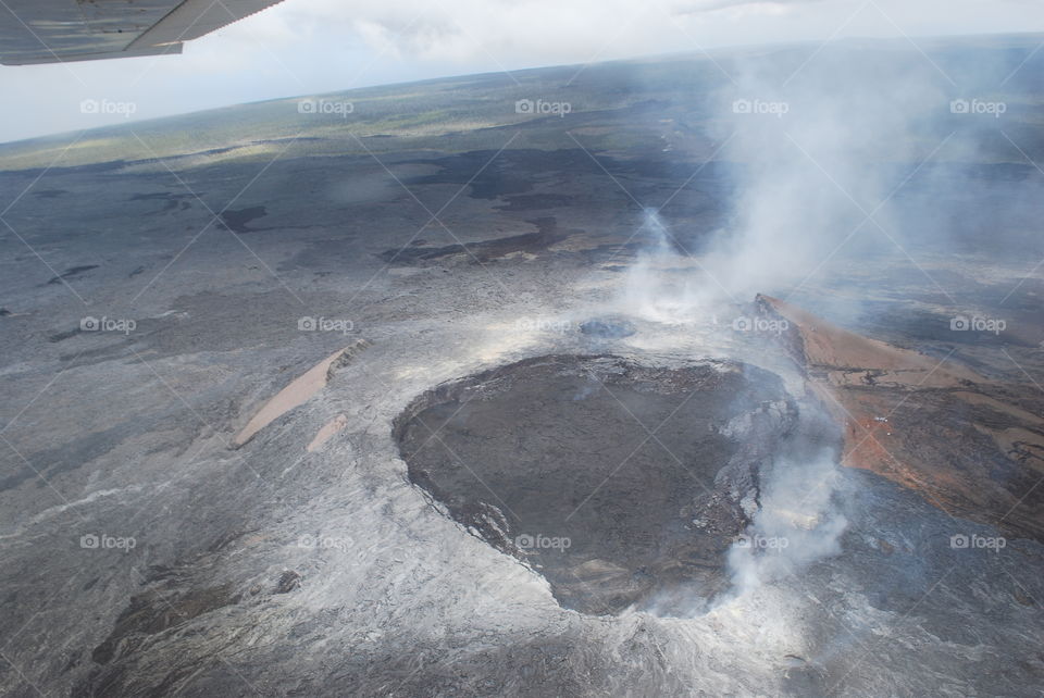 View of volcanic landscape against cloudy sky