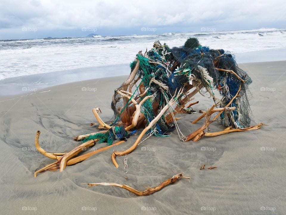 27th January 2025. 7:45am Location: Cua dai, an bang, Hoi an. Vietnam. A shelter on the beach, built from nature and man made material.