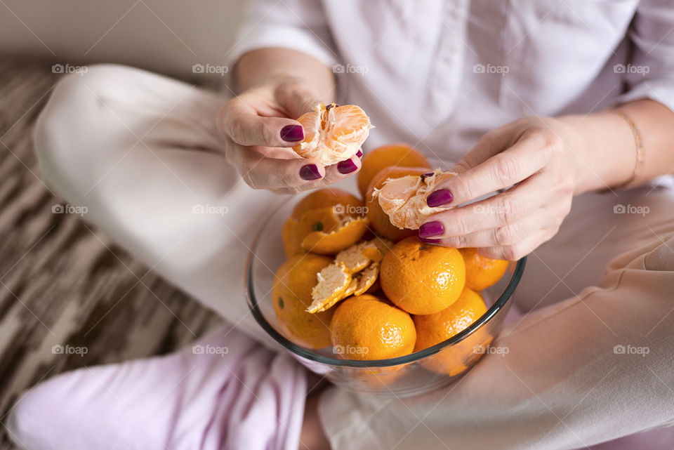 Woman cleaning tangerines