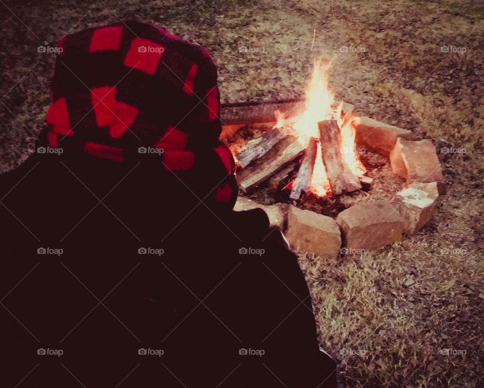 Person sitting near campfire