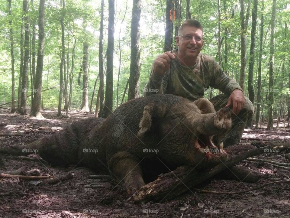Happy Bow Hunter with 650 pound Boar