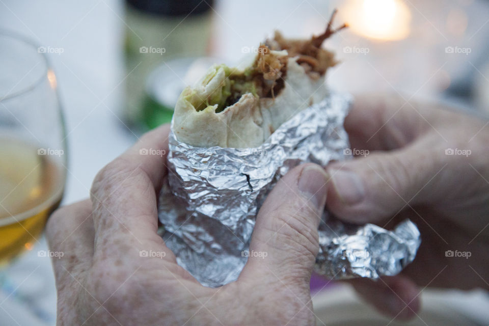 Close-up of person holding wrapping sandwich