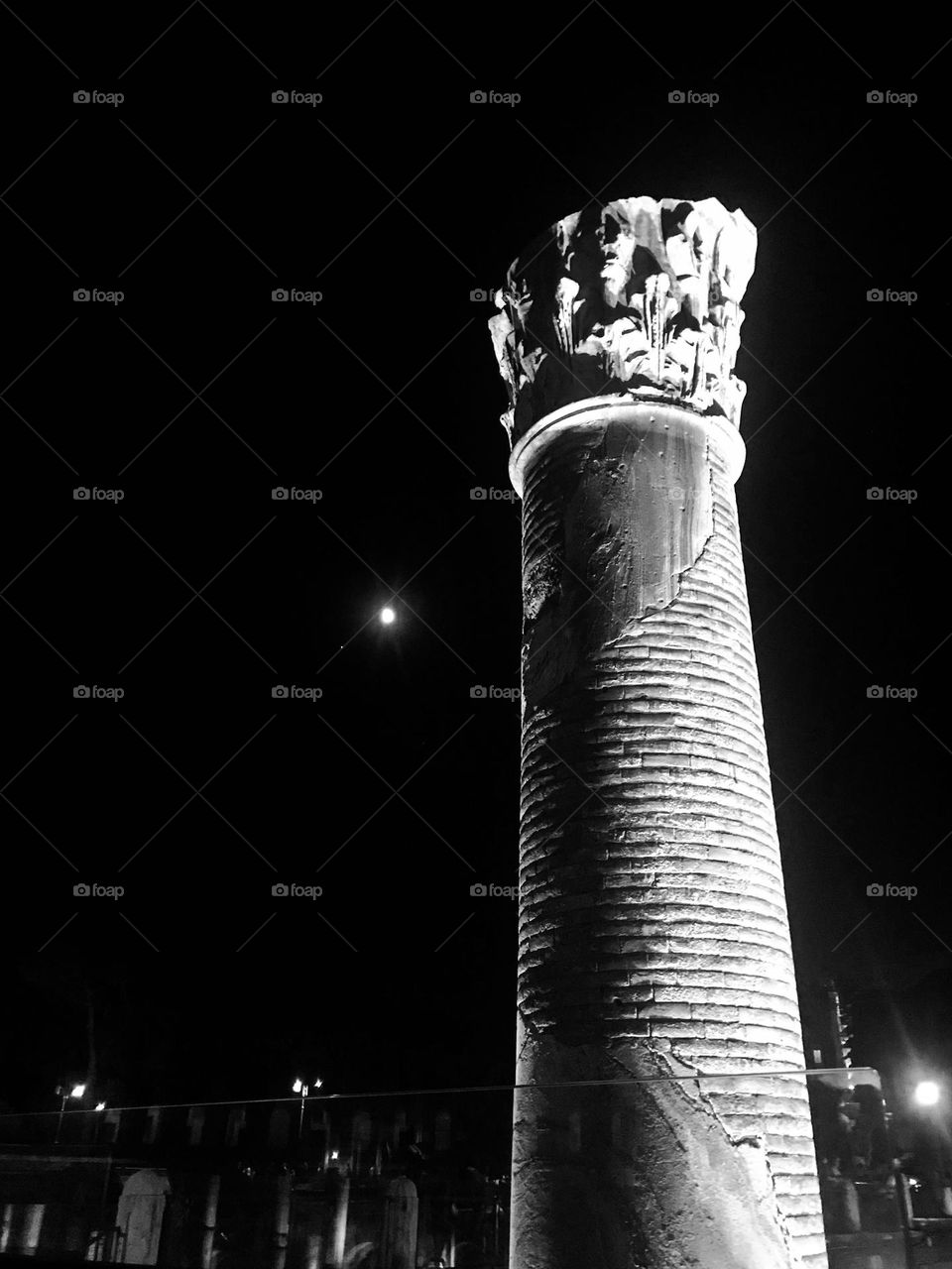 A column in Trajan’s Forum in Rome, Italy with a full moon in the background.