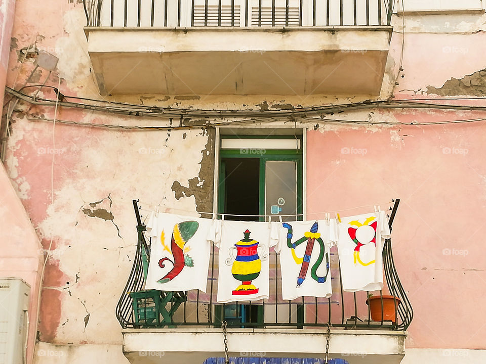 Poker aces. Aces drawing in a t-shirt lying to dry in a balcony in a old Italian house . This aces are typical in a deck of cards in Naples .