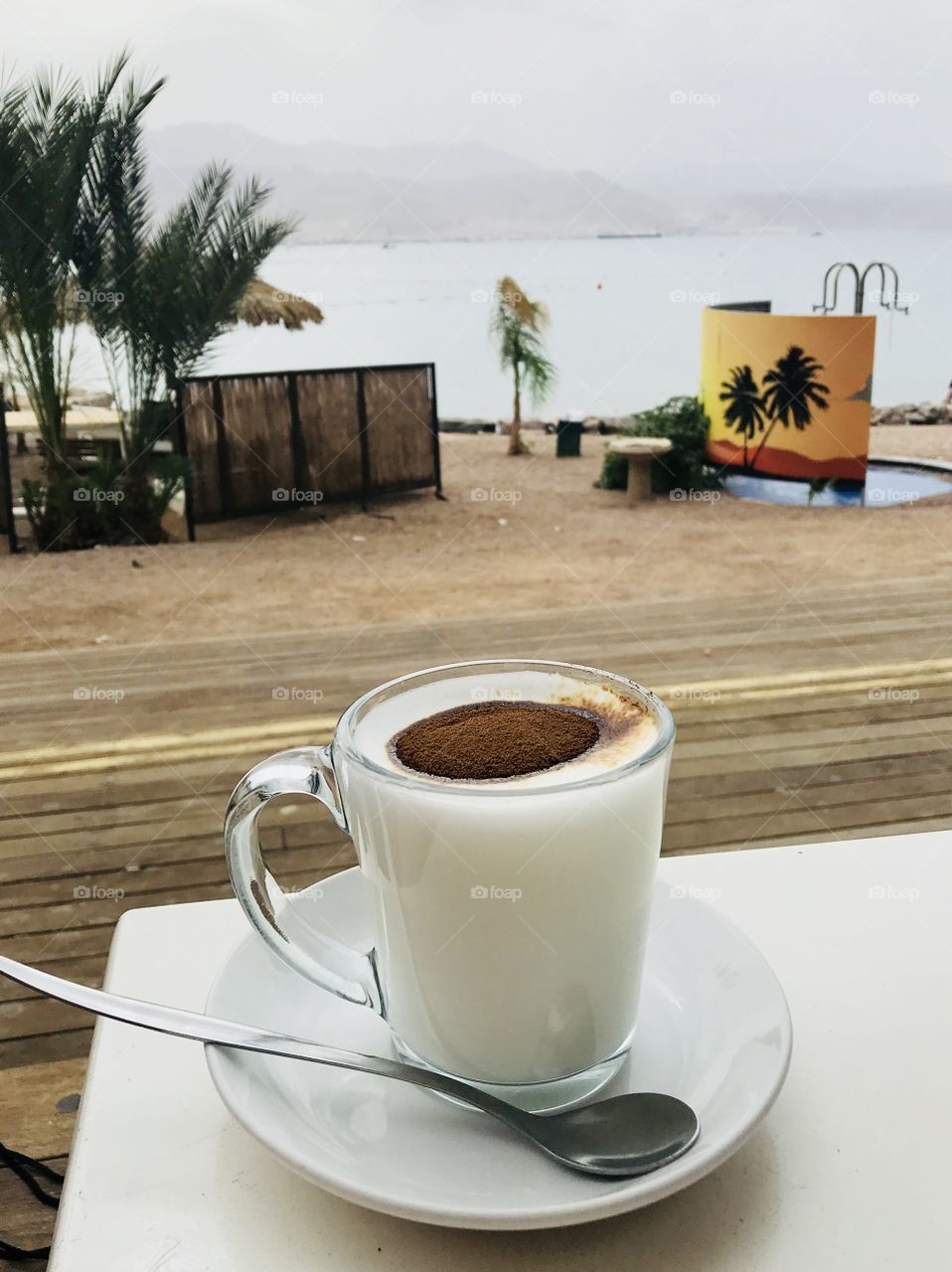 A cup of milky Coffee in a beach bar