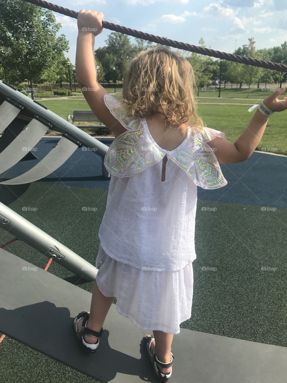 Adorable toddler on playground in fairy dress