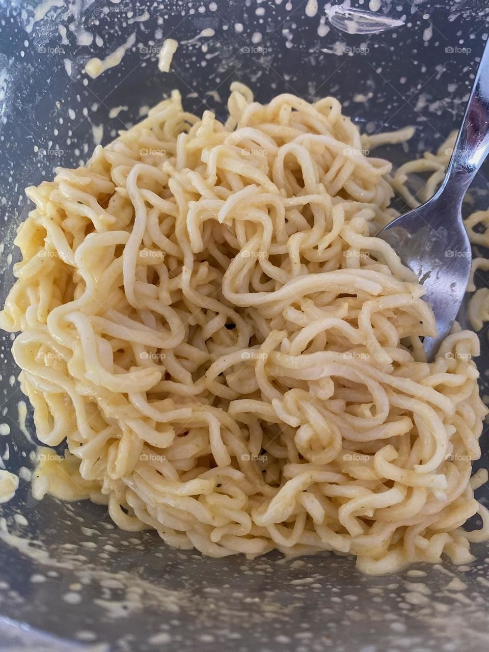 Ramen in a bowl with a fork. 