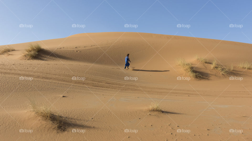 Berber Man Walking in Sahara Desert