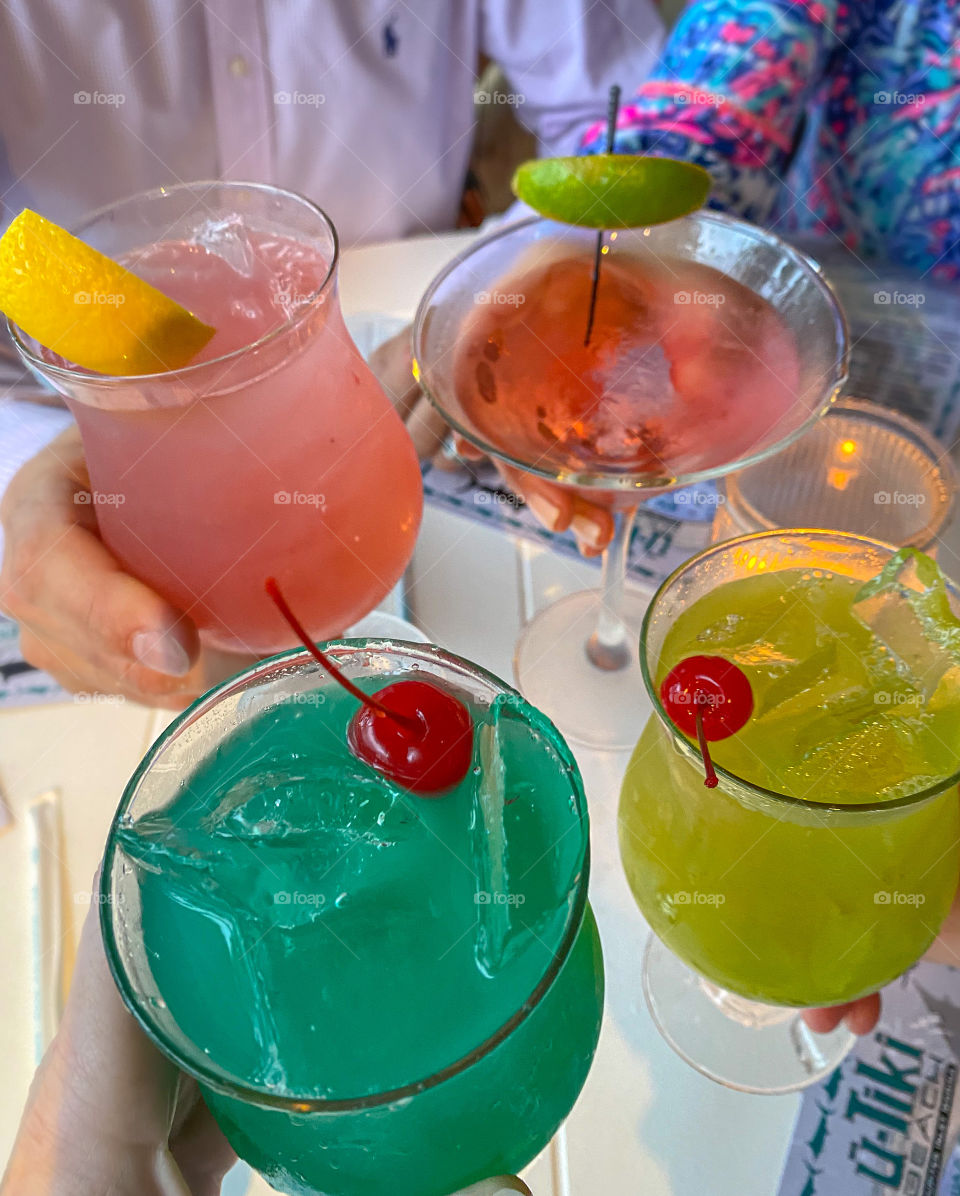 Having fun - enjoying cocktails and dinner out with friends.  Colorful drinks are fun, too. 