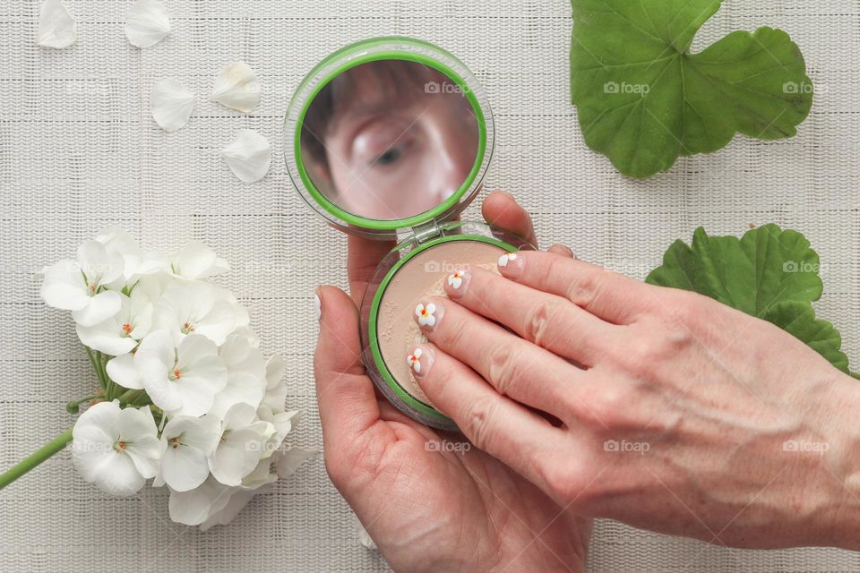 Woman is using make-up powder