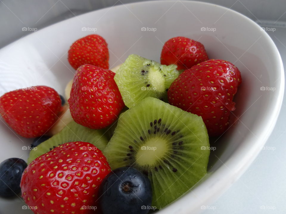 Healthy fruits breakfast full of vitamins with strawberry, kiwi, banana and berries