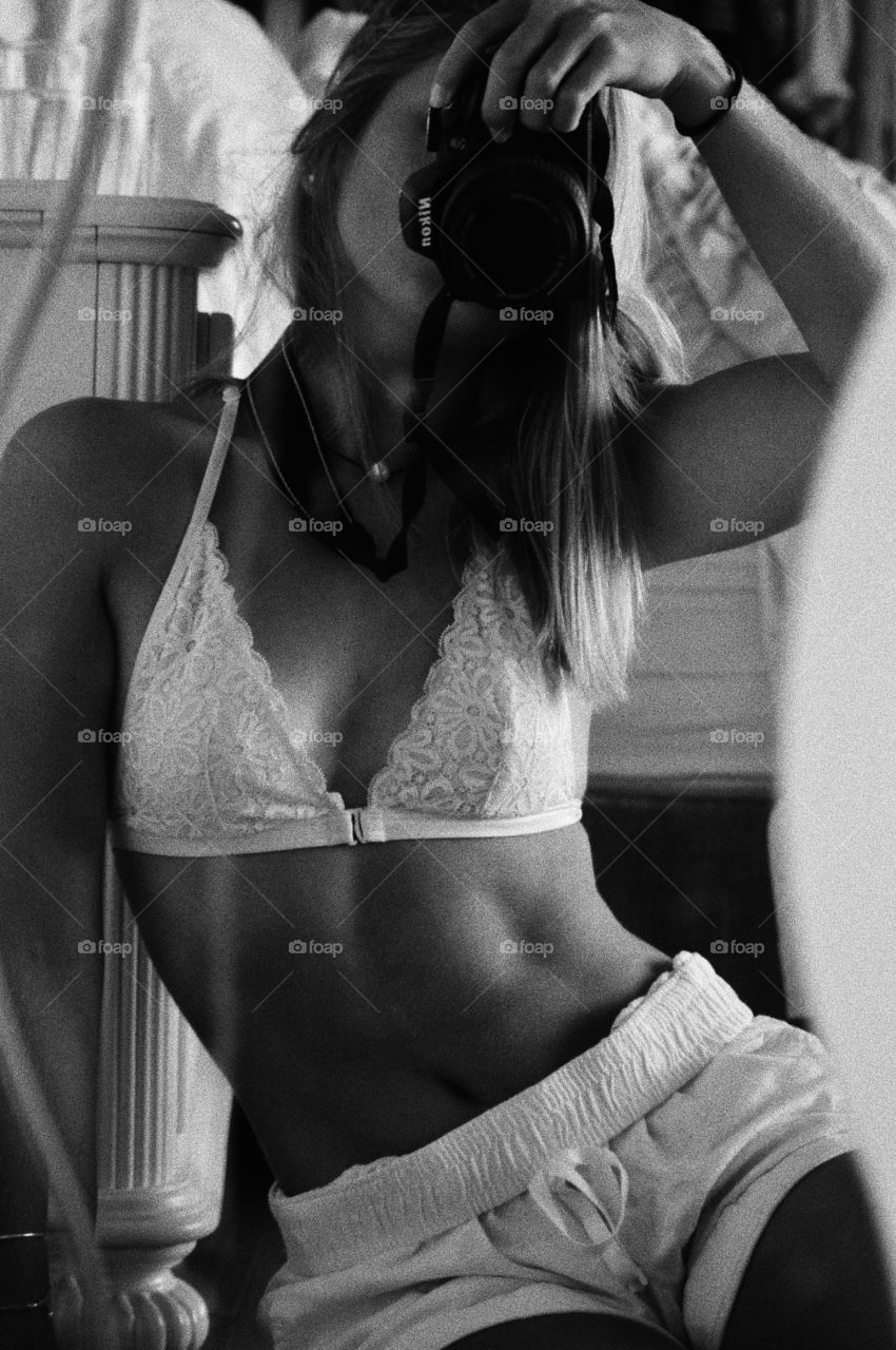 sexy girl posing in mirror bralette black and white 