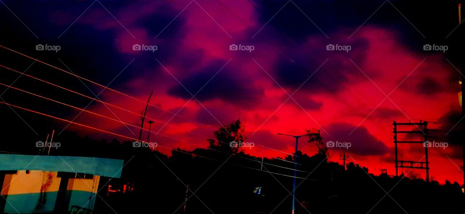 Lights: Natural vs Artificial .Captured the effects of Blood-red sky with clouds floating over the city before the storm.