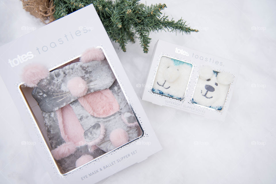 Flat lay of packaged gift sets in the snow for the holidays