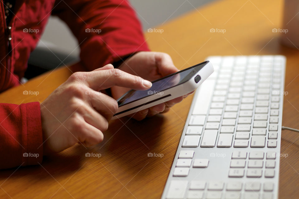 Close up of woman's hand using a mobile device. 