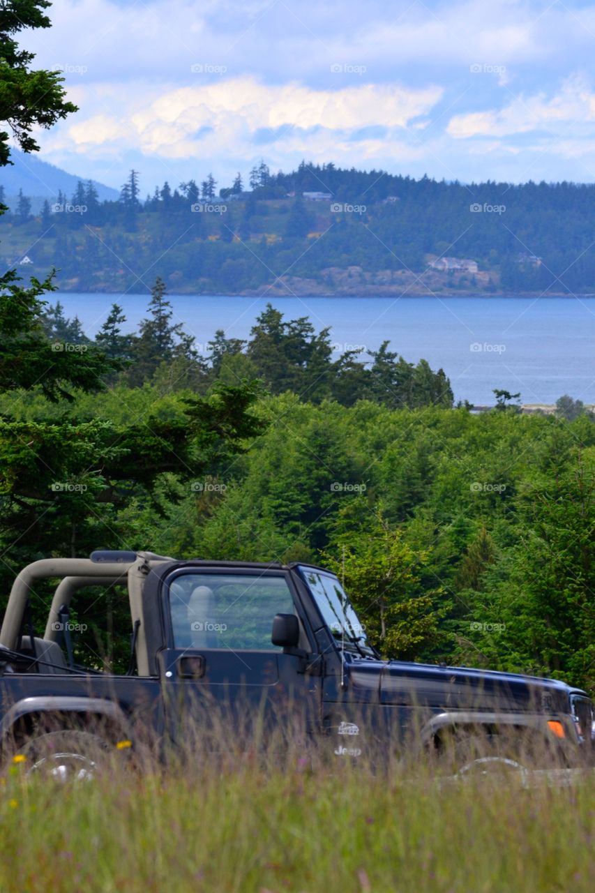 Rental jeep with a view photo taken of the San Juan islands Washington