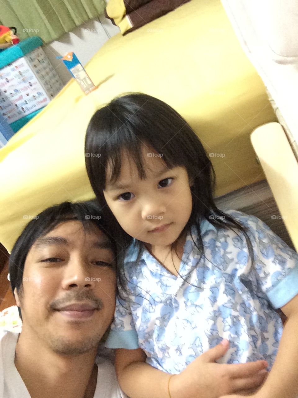 Asian girl and her father in pajamas 