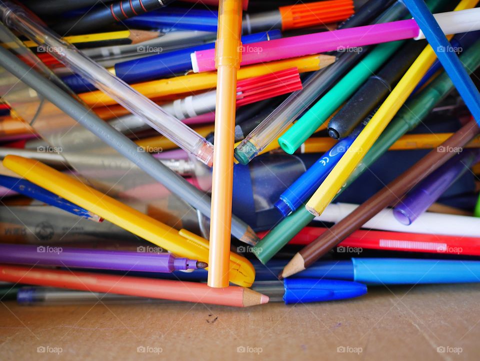 Colored pen and pencils in a box