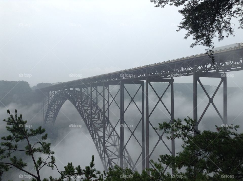 Elevated railroad bridge during foggy weather