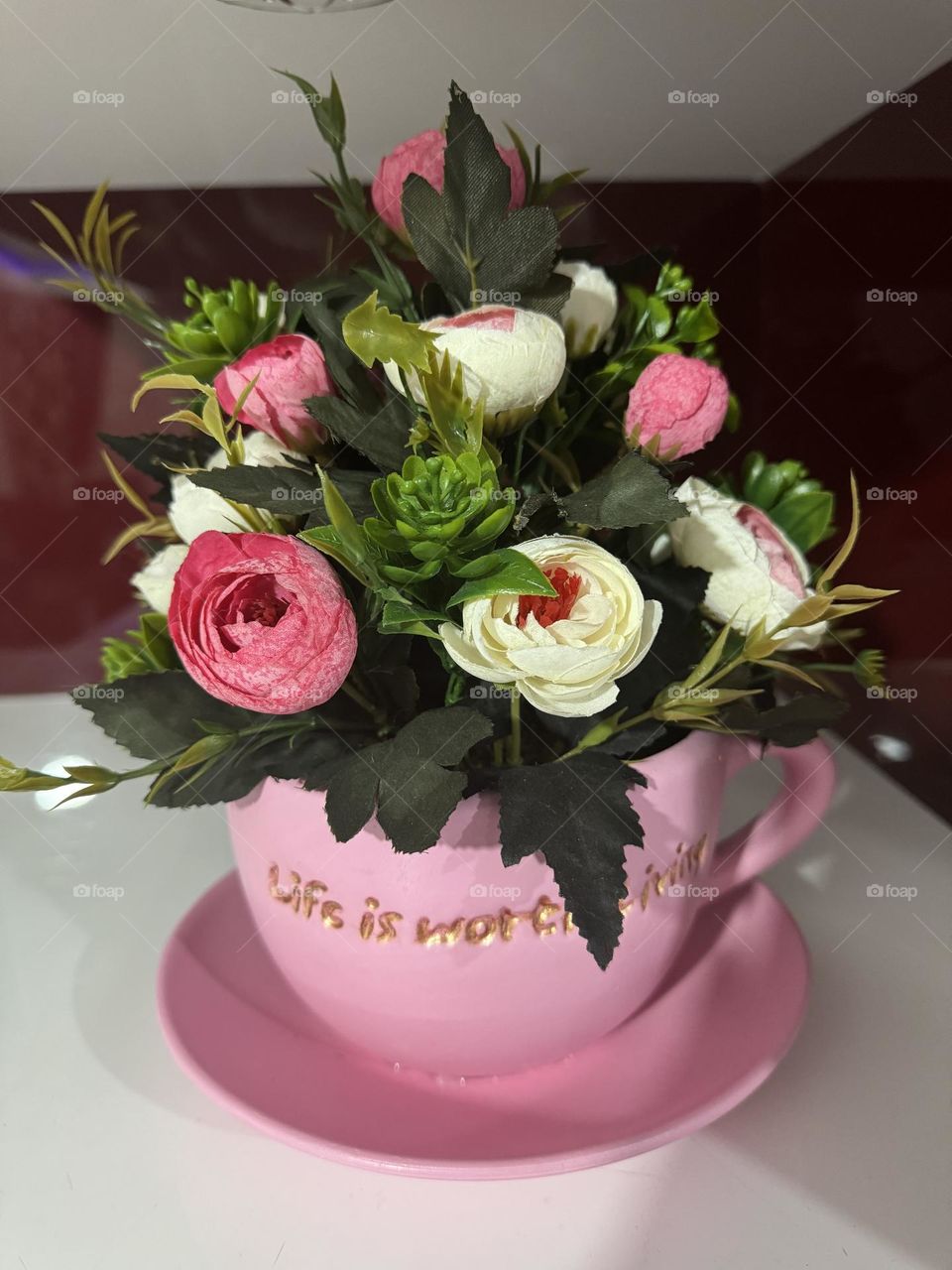 The shape of a cup vase with beautiful colored flowers