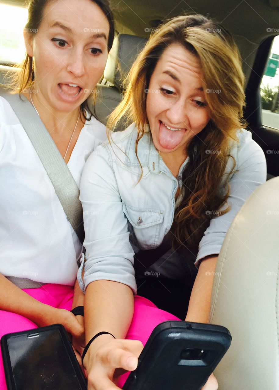 Two friend taking selfie in car
