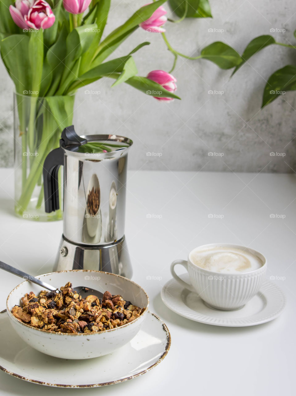 Granola breakfast with coffee and flowers