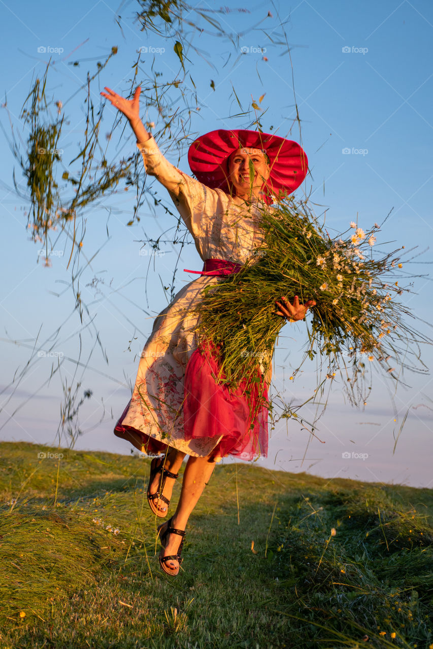 A Happy Young Woman with an Armful of Flowers