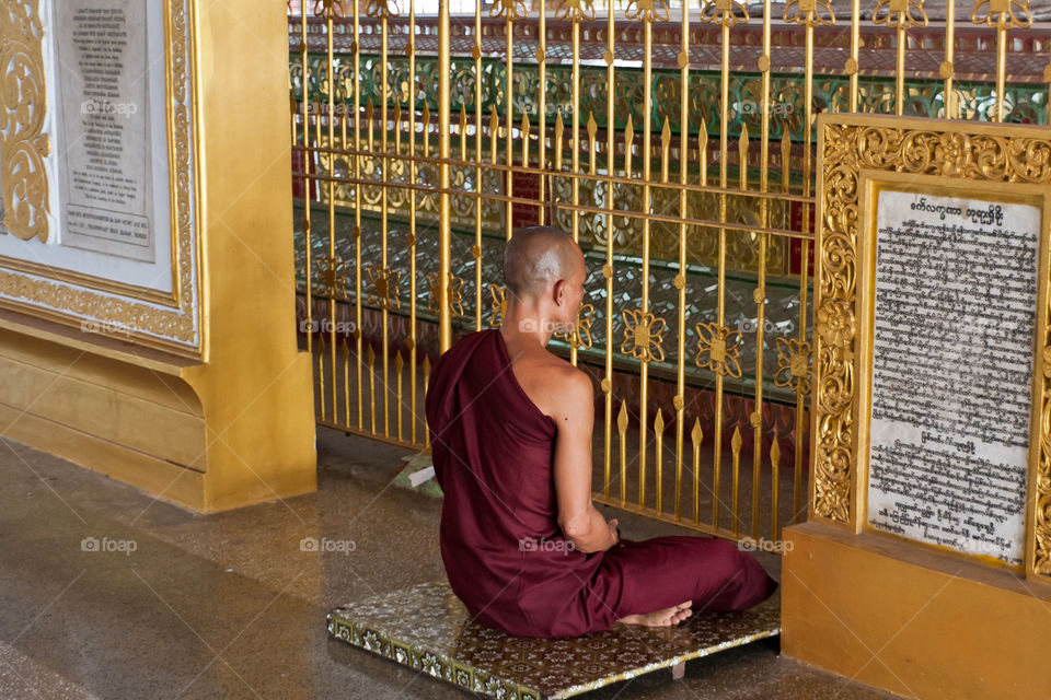 A male Buddhist monk meditating in the pagoda, Myanmar