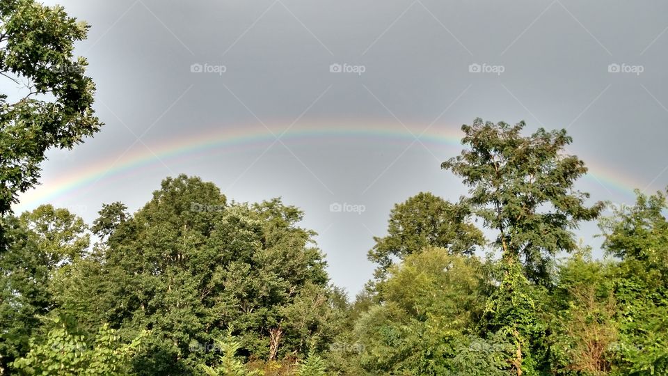 Beautiful afternoon after the rain rainbow