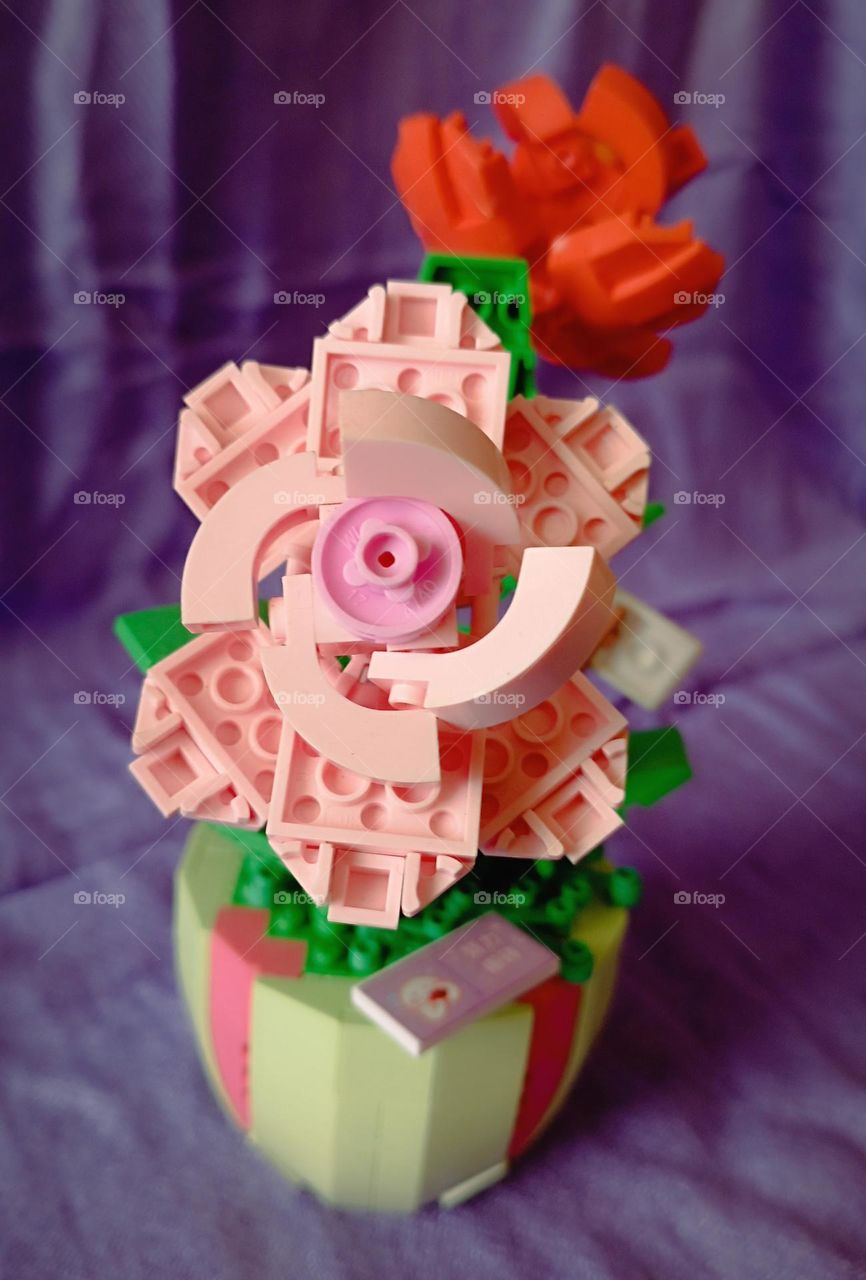 Lego roses with purple sheet as background