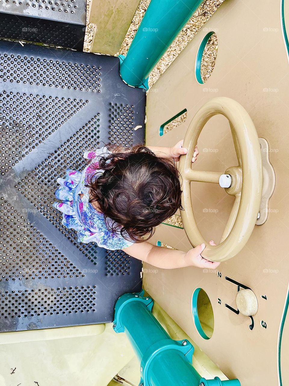 Circles at the park, little girl pretending to steer with steering wheel, driving the car, park fun outside, circular shapes at the park, finding circles, toddler girl plays outside, playgrounds in small towns 