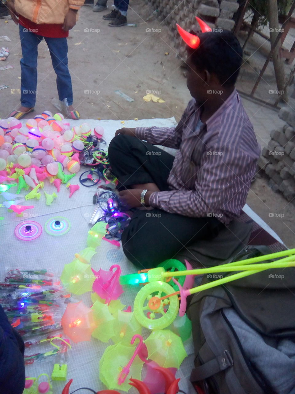 a man selling toys in a fair.