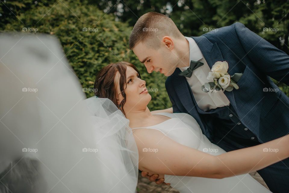 Brides in love look into each other's eyes before a sweet kiss