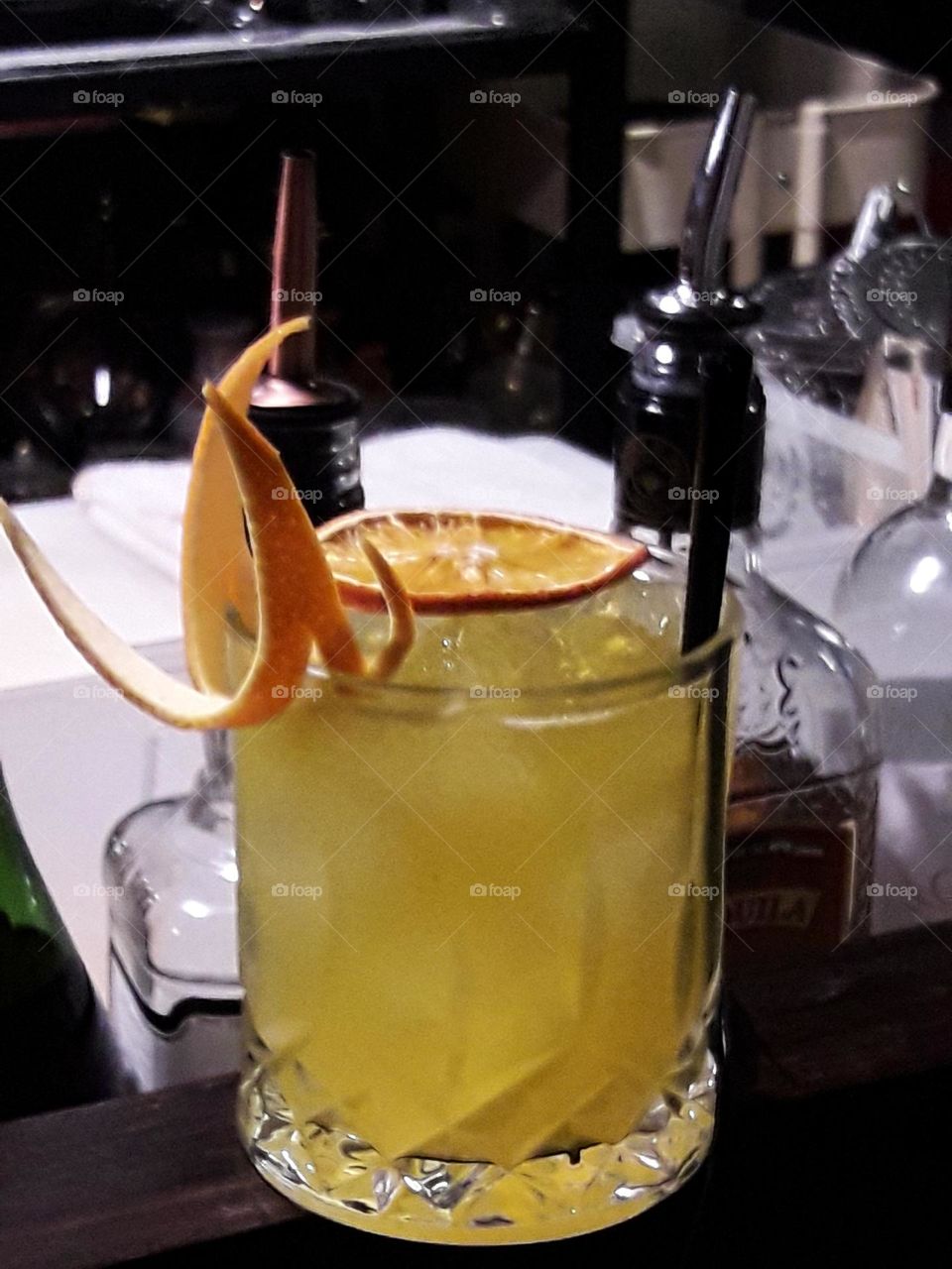 Yellow cocktail with orange slices