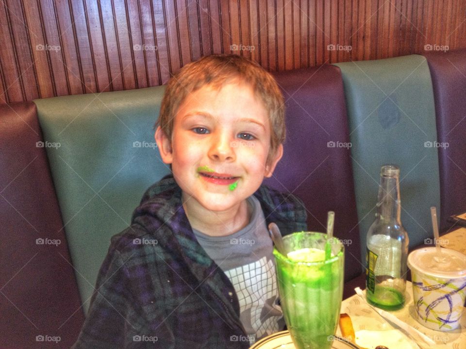 Boy Drinking Milkshake. Young Boy Drinking Green Milkshake
