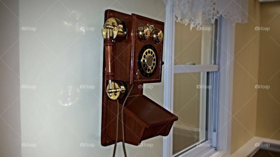 Antique Telephone on the wall. This old fashioned phone was taken as it is pined on the wall and I think it's a lovely and good gismo.