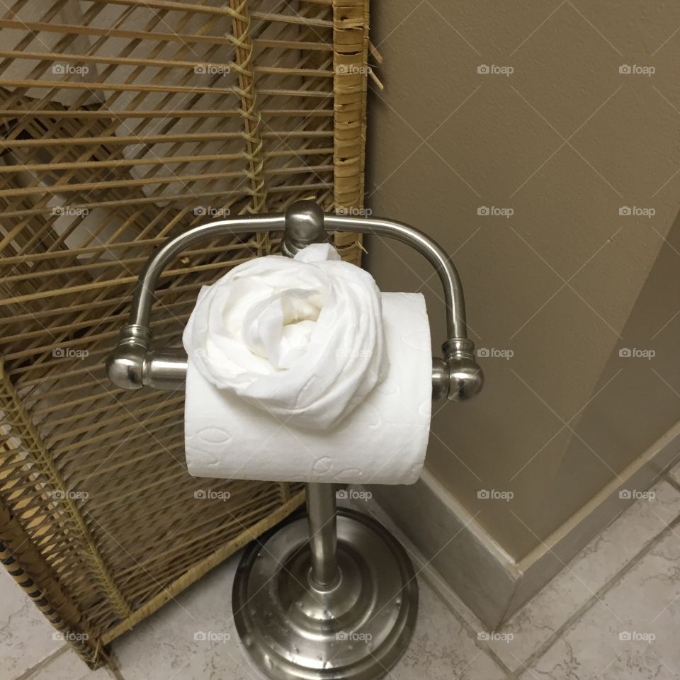 A clean bathroom, toilet paper decorated 