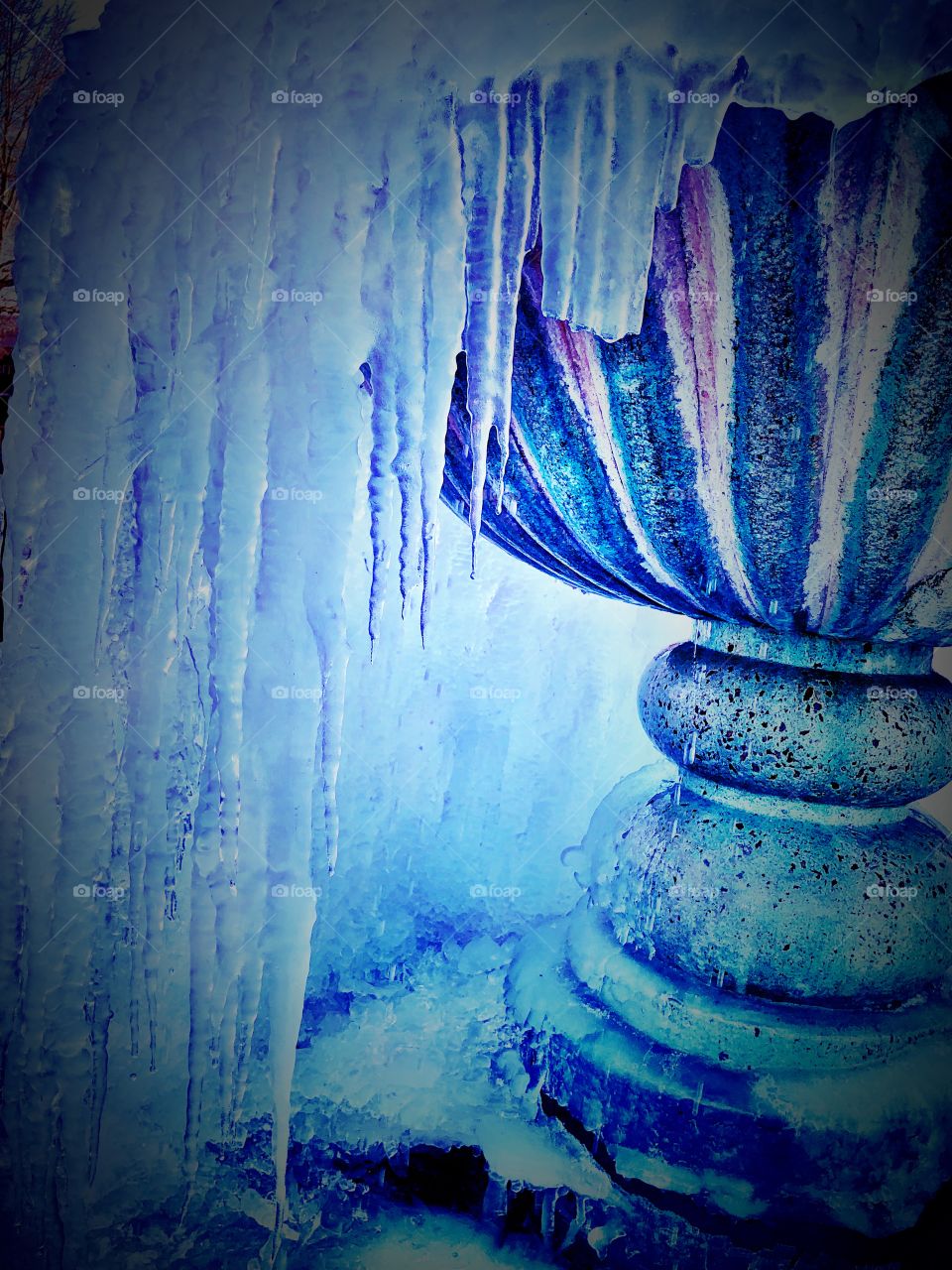 Frozen water fountain close up on dripping icicles 
