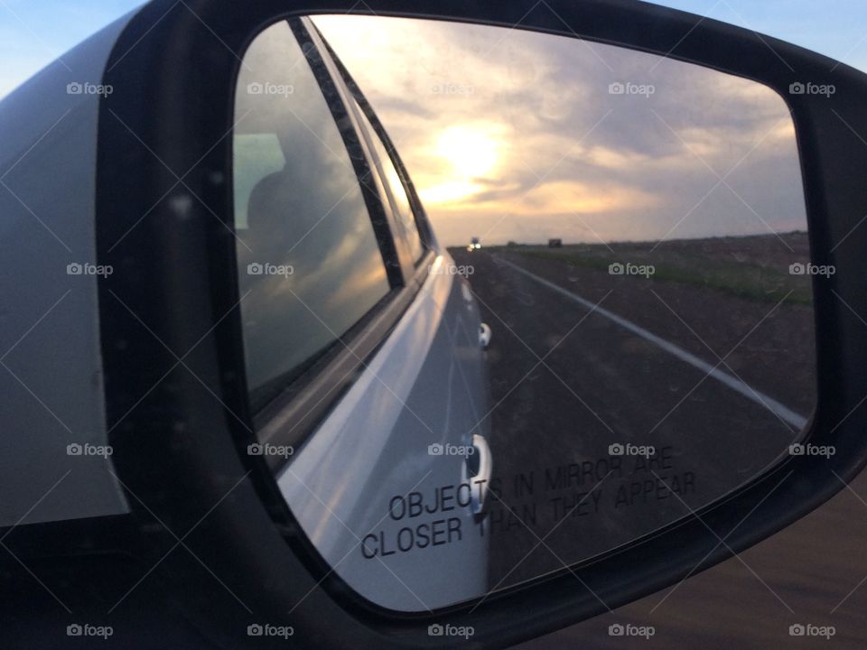 Car mirror . Sunset