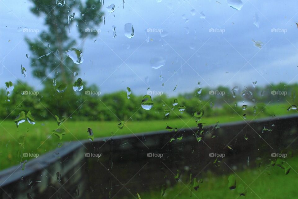 Tranquil photo of raindrops on a window during a rain storm. 