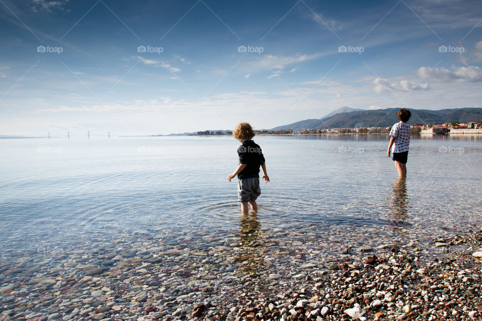 two children in water Gribovo beach Nafpaktos Naupactus Gulf of Corinth