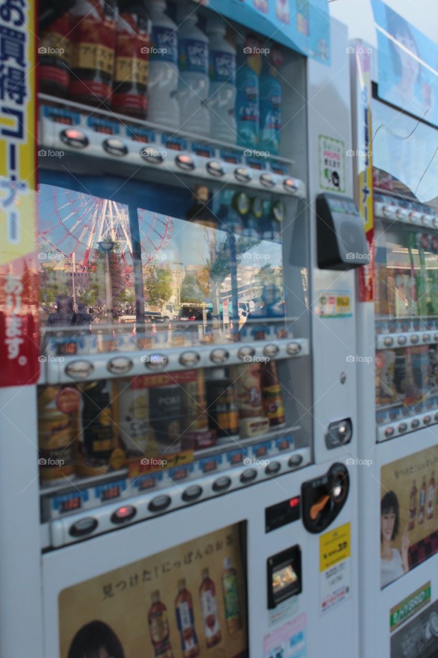 Vending machine with Ferris wheel reflection 
